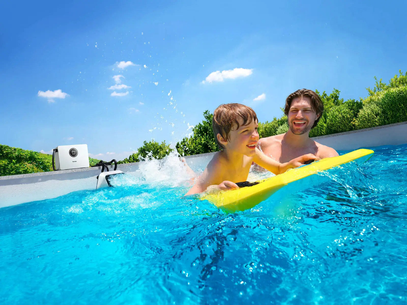 Child in pool with portable swim jet in the background